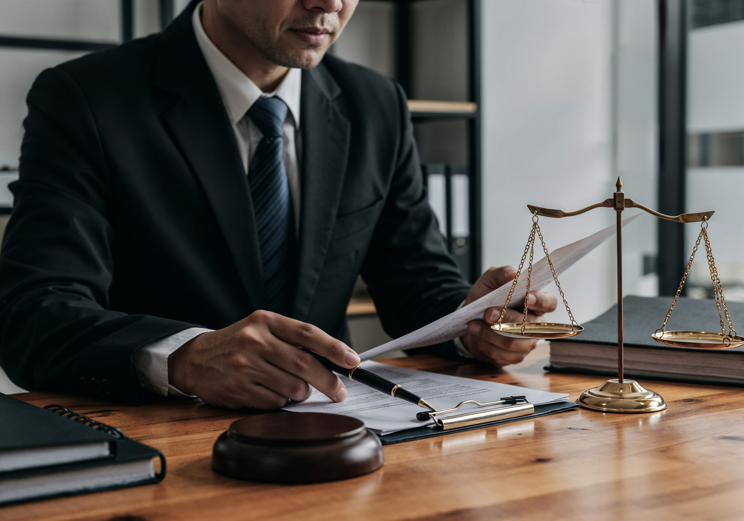 lawyer-working-document-with-scales-justice